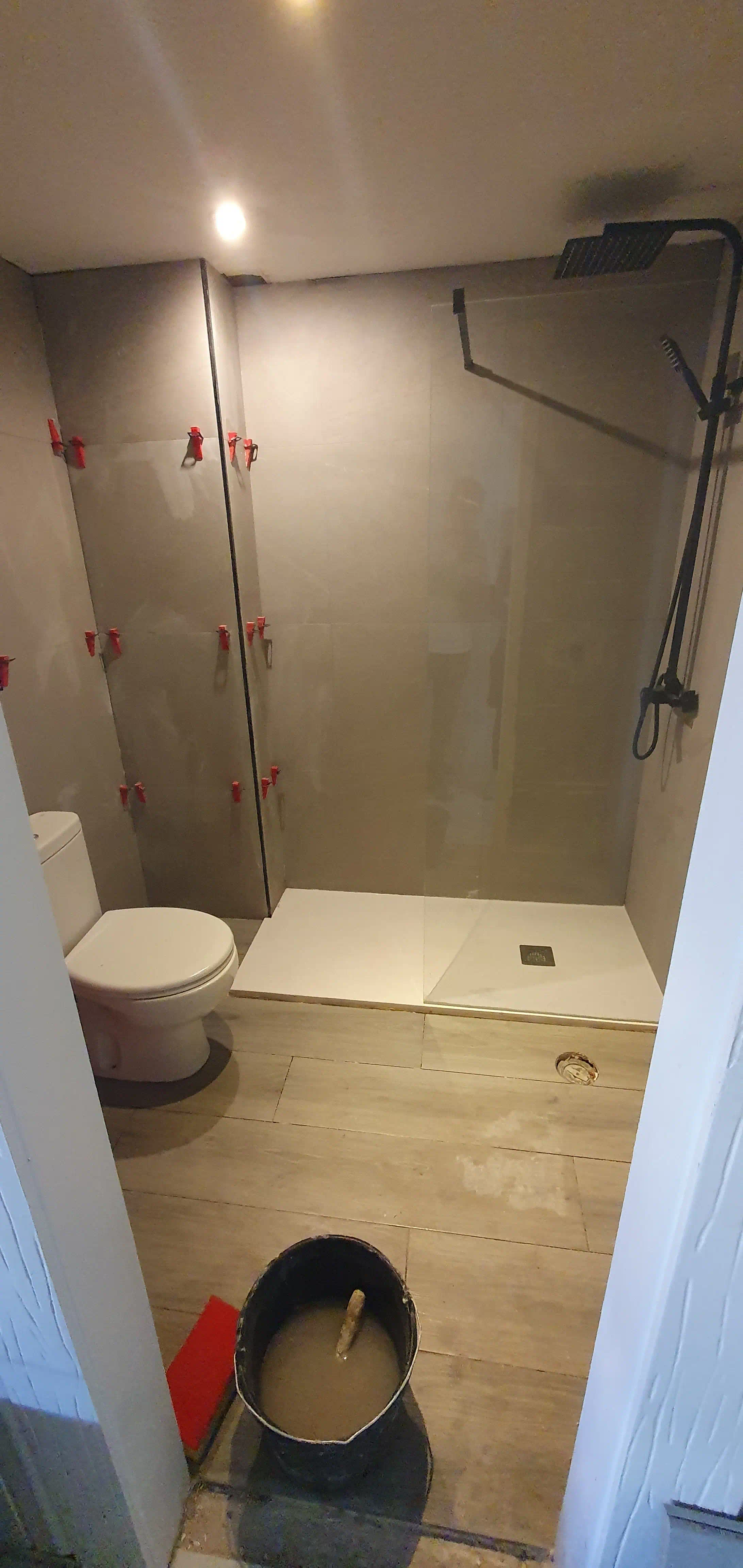 Inodoro ecológico de doble descarga instalado sobre suelo porcelanato efecto madera